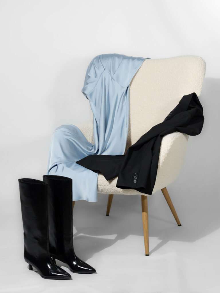 Cozy chair with clothes draped over it, representing the online personal styling service.